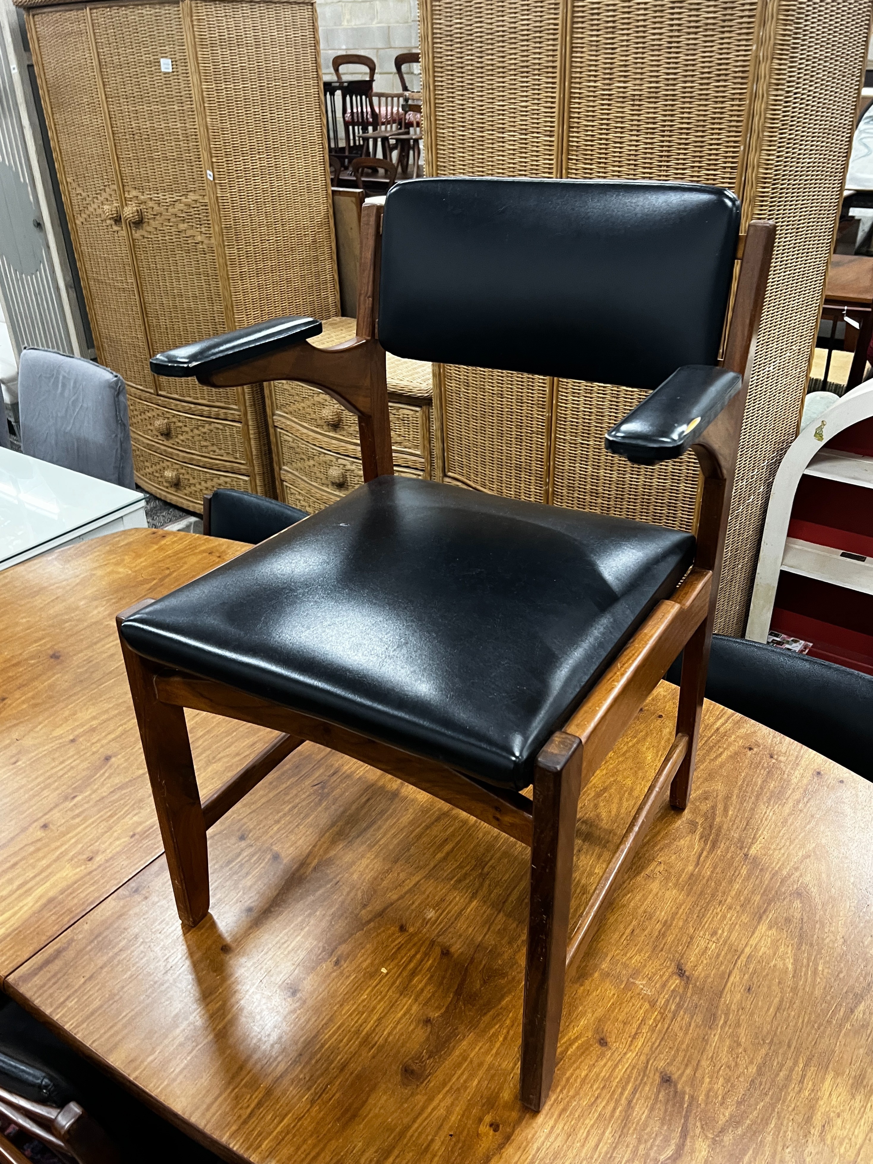 A mid century Novocraft teak dining suite comprising extending dining table 230cm extended, width 97cm, height 74cm, seven black leatherette chairs, one with arms and a sideboard width 178cm.